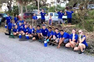 Sebastian River High School band members help clean up neighborhood.