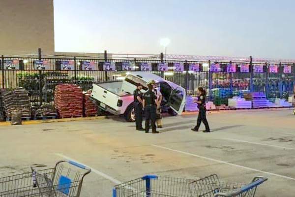 Man drives truck on mulch in outside Garden Center at Walmart in Sebastian, Florida.