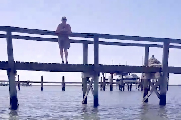 Joyce Khatibi yells at fisherman Jose Ortiz from her dock in Vero Beach.