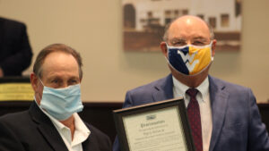 Kip Kelso (left) receiving an award from Mayor Ed Dodd (right).