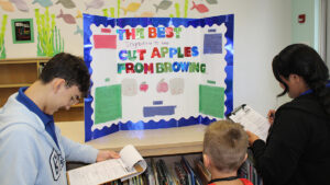 High school Navy JROTC Cadets judge elementary science fair in Sebastian, Florida.