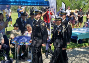 From left: Cadets Trevor Johnston, Ava Anderson, and Matthew Acosta march in review past WWII Merchant