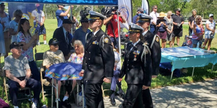 From left: Cadets Trevor Johnston, Ava Anderson, and Matthew Acosta march in review past WWII Merchant