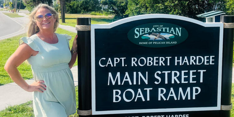 Scarlett Chesser in front of the Capt. Robert Hardee Main Street Ramp sign, marking a notable spot in the city