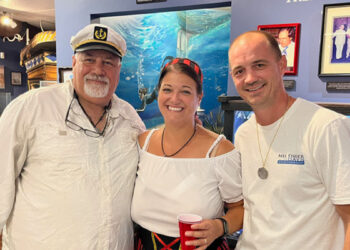 Vincent Trotta, left, Captain of the Mel Fisher’s Treasures company search and recovery vessel “DARE,” poses with Mel and Deo Fisher’s granddaughter Nichole Johanson and her husband James, in Sebastian, FL, during a Mel Fisher Days event. (Photo Credit: Jim Wilson)